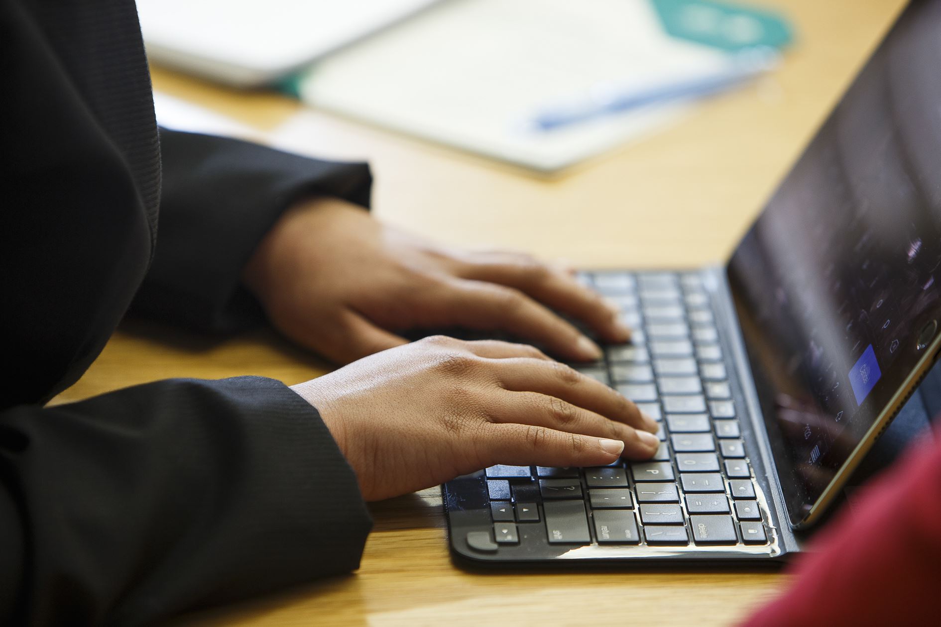 Close up of hands on a laptop keyboard