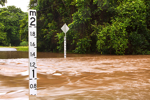 Rising floodwaters - Flooded road with depth indicator